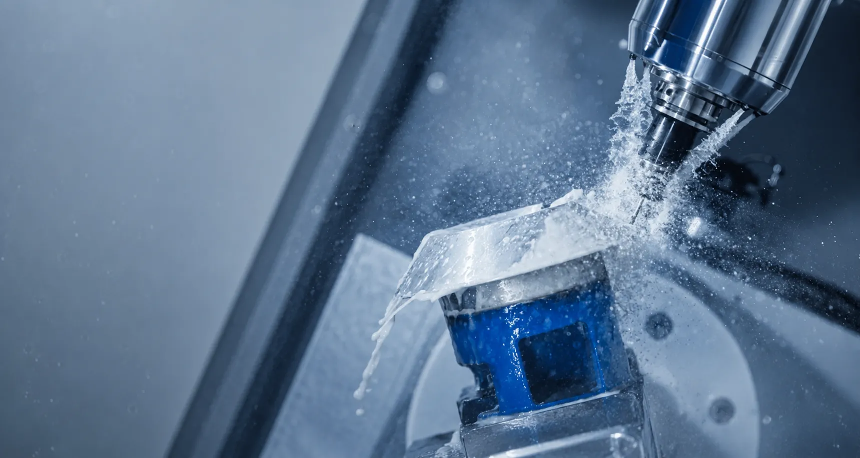 5-axis CNC machine milling a metal workpiece under coolant