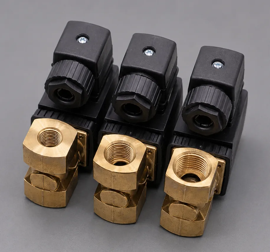 Three brass aerospace components with threaded openings