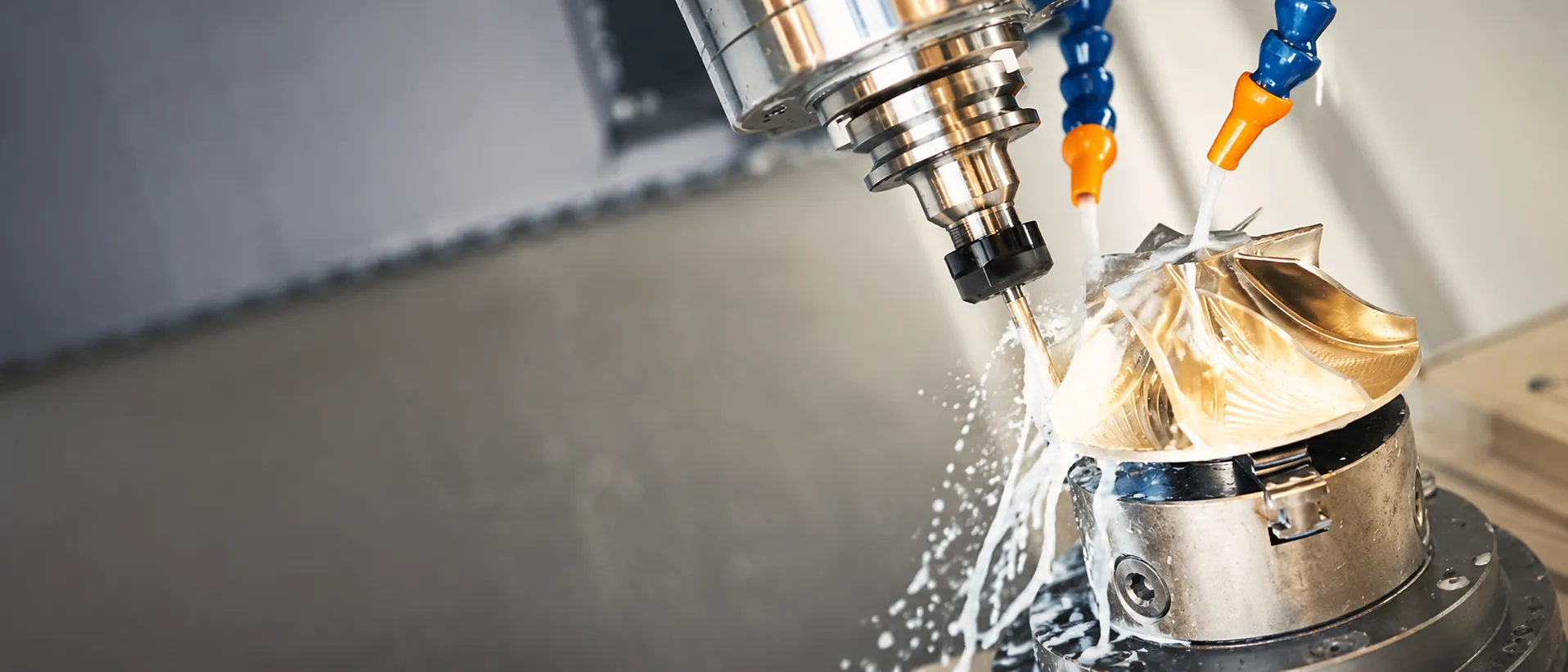 CNC milling spindle cutting a metal impeller with coolant