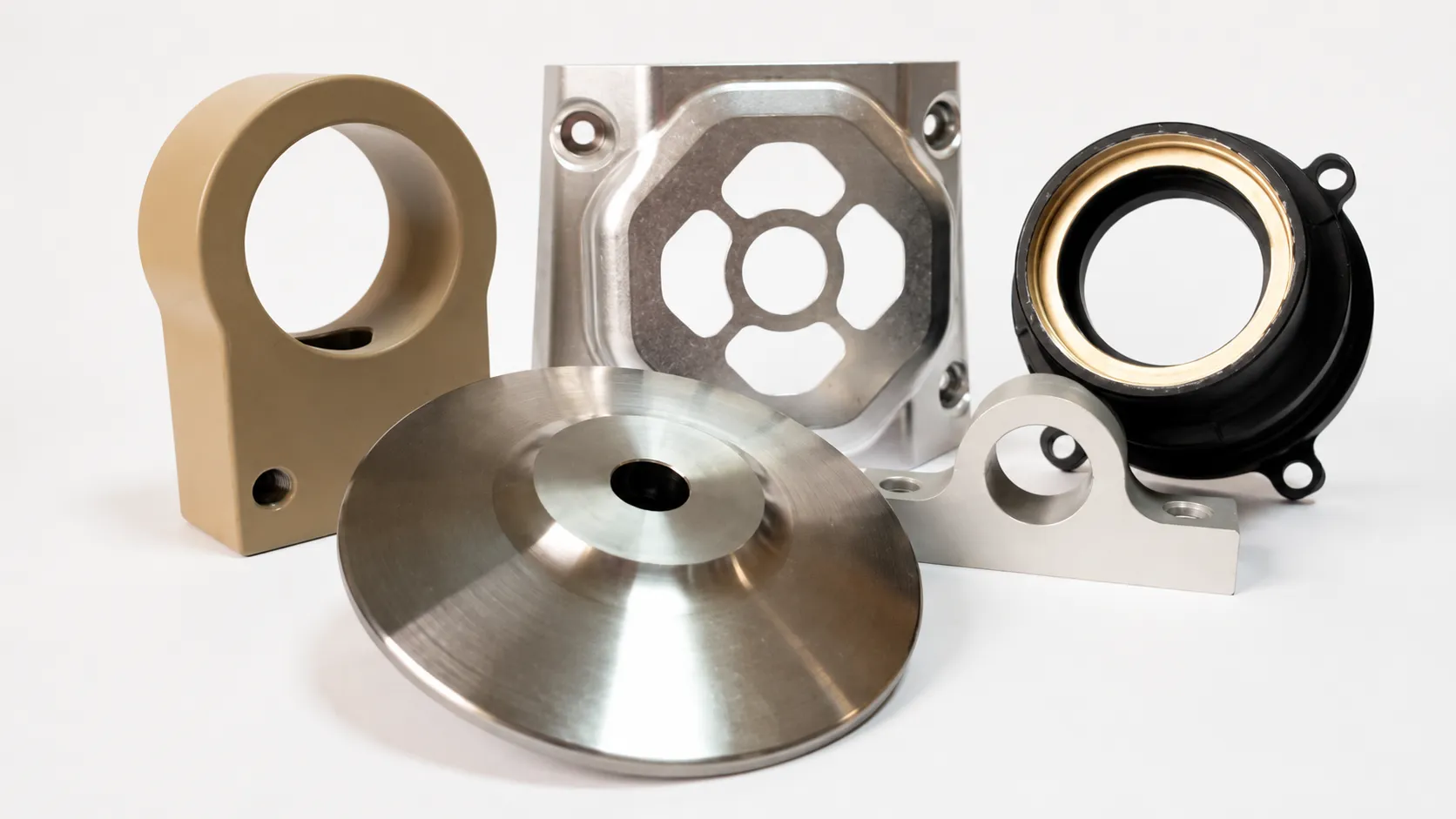 Assorted machined components displayed on a white background